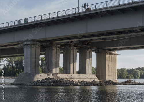 Supports of an automobile bridge. Concrete supports. Bridge under construction. Urban landscape