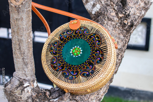 Fashionable stylish rattan bag outside. Tropical island of Bali, Indonesia. Rattan handbag. photo