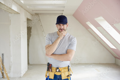 Professional young construction worker man portrait