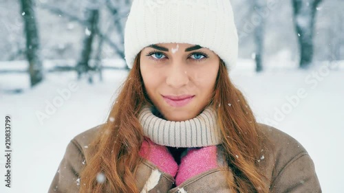 Happy woman at cold snowy winter at New York Park