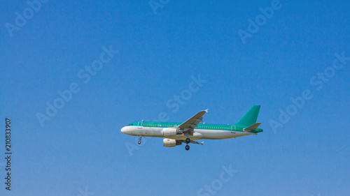 Jet passenger airplane flying with blue sky background.