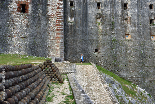Traveller before curtain walls of the French Citadelle la ferriere built on the top of a mountain photo