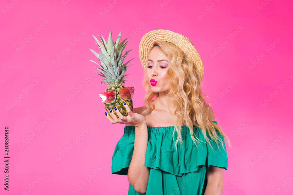 Fashion portrait young beautiful woman with pineapple over pink background Fashion portrait young beautiful woman with pineapple over pink background