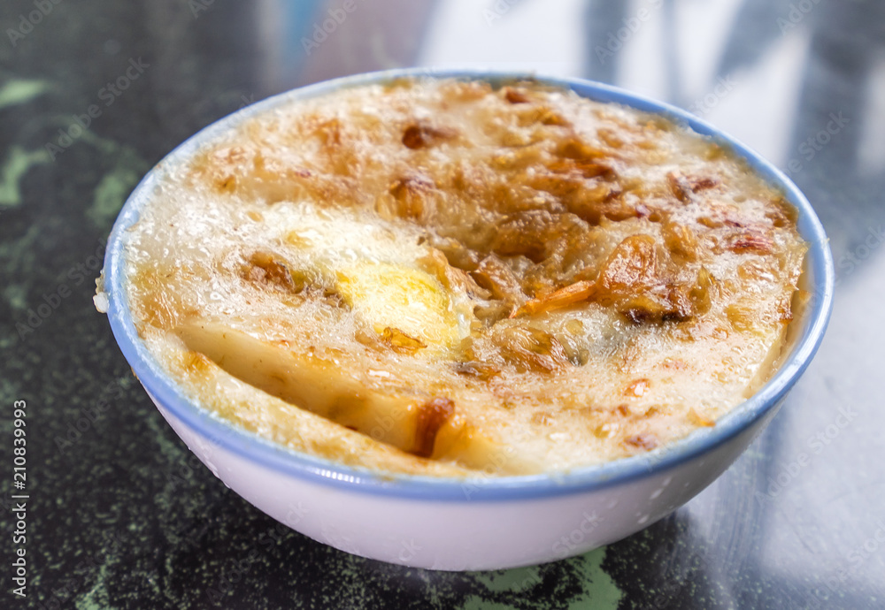 Taiwan's distinctive famous snacks: Savory rice pudding (Wa gui) in a white bowl on stone table, Taiwan Delicacies, Taiwan Street Food Taiwan's distinctive famous snacks: Savory rice pudding (Wa gui) in a white bowl on stone table, Taiwan Delicacies, Taiwan Street Food