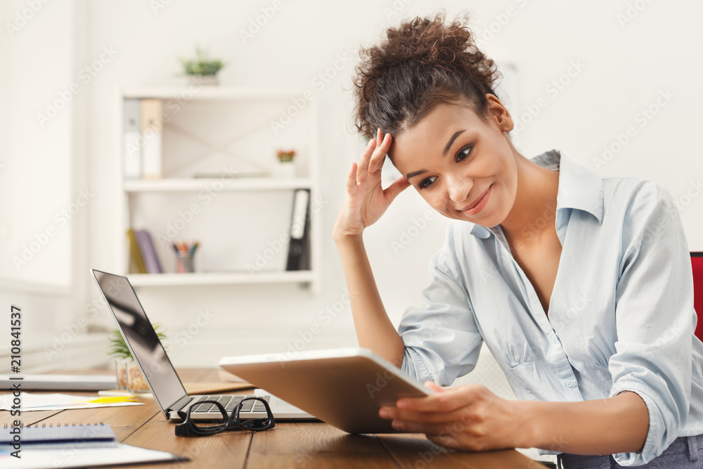 Black business woman working on digital tablet Black business woman working on digital tablet