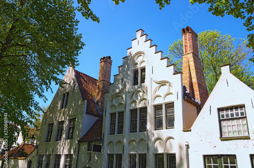 Beautiful traditional houses in the old town of Bruges (dutch: Brugge), Belgium. Spring landscape photo. Selective focus with wide angle lens photo