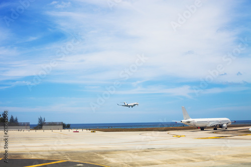 Summer landscape with airport with flying airplane in Phuket, Thailand