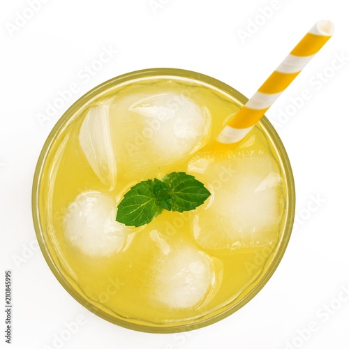 Top view of yellow soft drink in glass. Isolated on white background