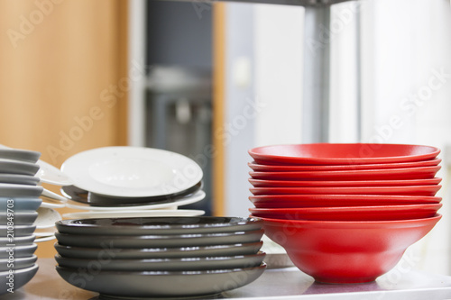 Stacks of plates of red and gray color