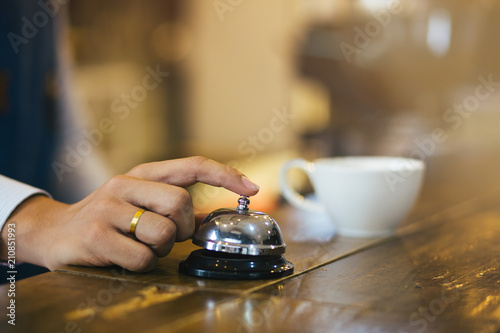 Close-up Finger press bell. Restaurant bell