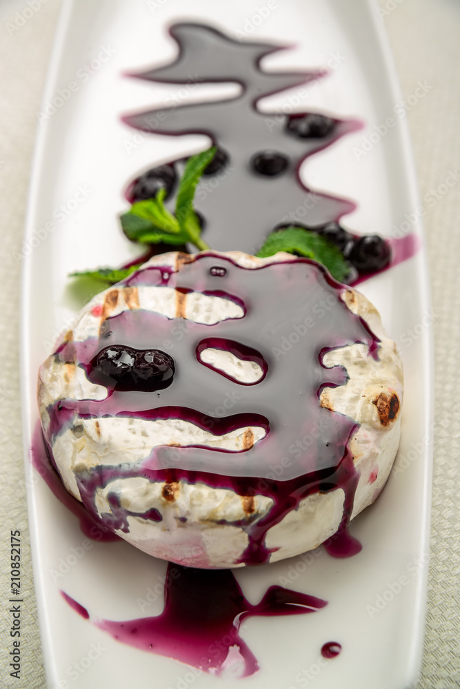 Fototapeta premium baked Camembert cheese with cranberry sauce and mint