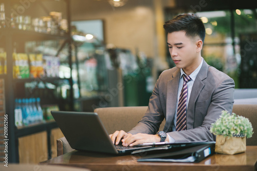 Young businessman sitting at a coffee shop.