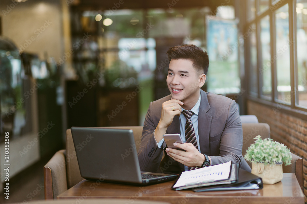 Fototapeta premium Young businessman sitting at the coffee shop.