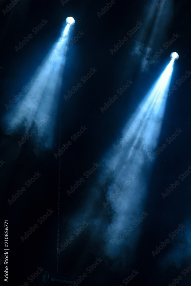 abstract image with rays of colored light in the dark