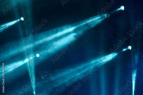 abstract image with rays of colored light in the dark