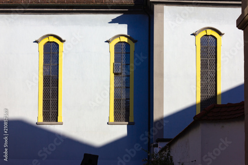 catholich church with blue yellow facade on blue sky photo