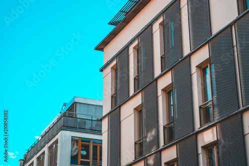 white apartment building with steel lens hood © Robert Herhold