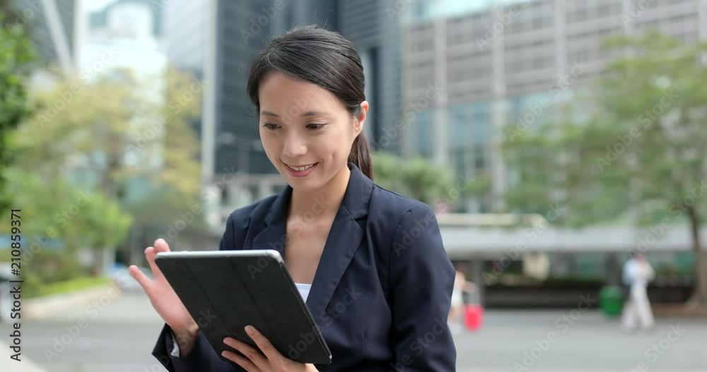 Businesswoman check on tablet computer at outdoor Businesswoman check on tablet computer at outdoor