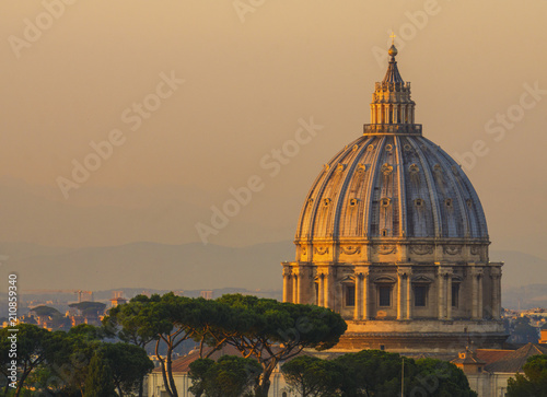 View of St Peter's basilica dome at sunset in Rome, Italy