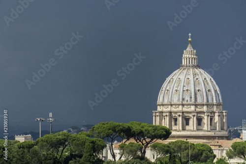View of St Peter's basilica with dark storm clouds in Rome, Italy