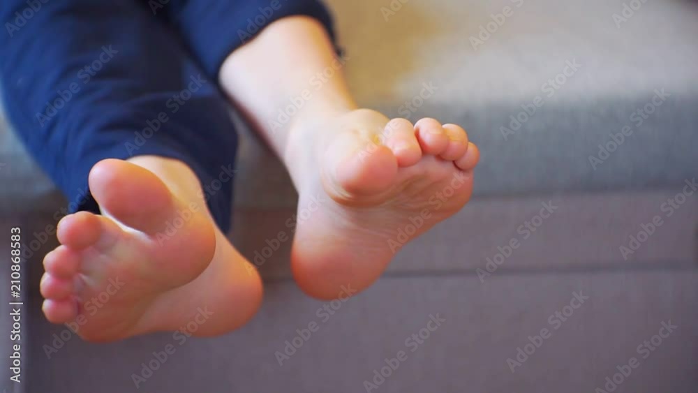 children's legs without socks carefree lying on the couch children's legs without socks carefree lying on the couch