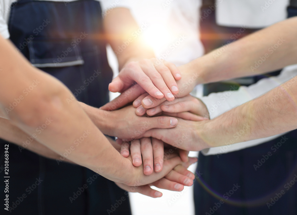 Team of movers showing unity, People putting their hands togethe Team of movers showing unity, People putting their hands togethe
