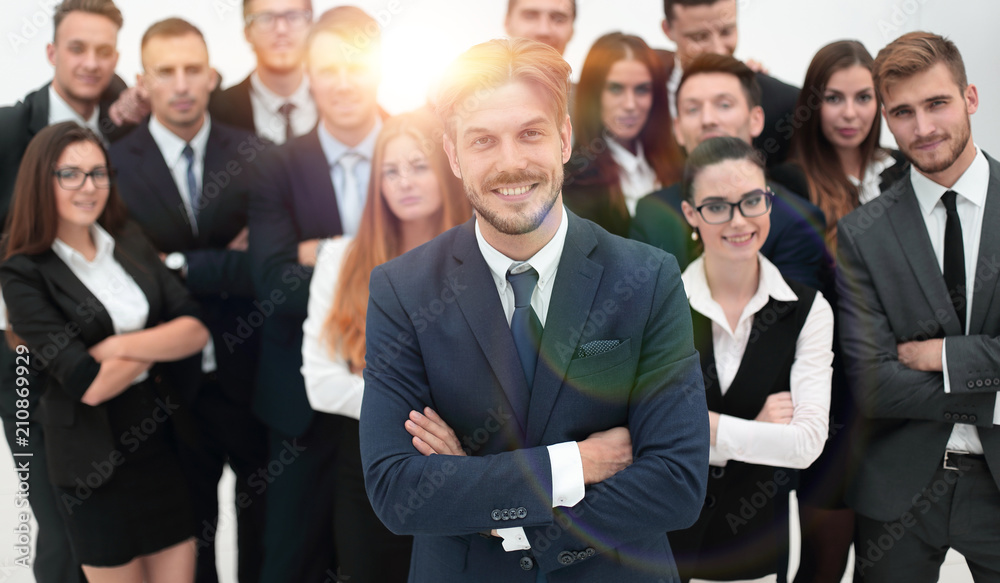 smiling businessman standing on background of her business team. smiling businessman standing on background of her business team.