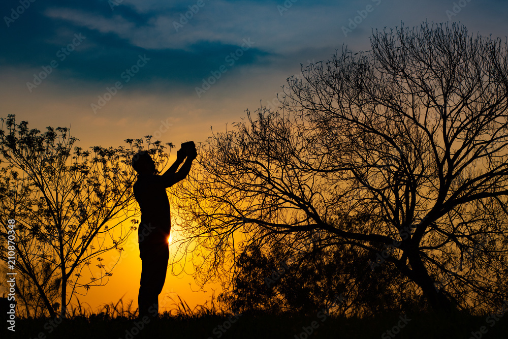 Man meditating in the field at sunrise Man meditating in the field at sunrise