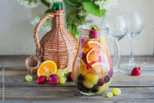 Homemade refreshing fruit sangria or punch with champagne  strawberries  oranges and grapes.