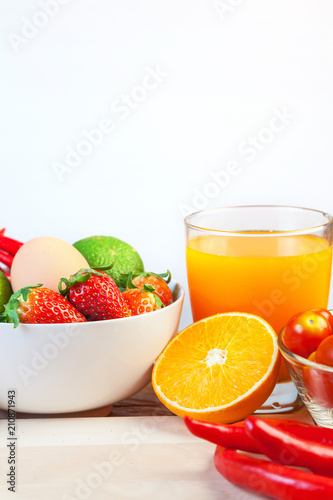 Healthy concept with mixed fruits and vegetables on wooden background