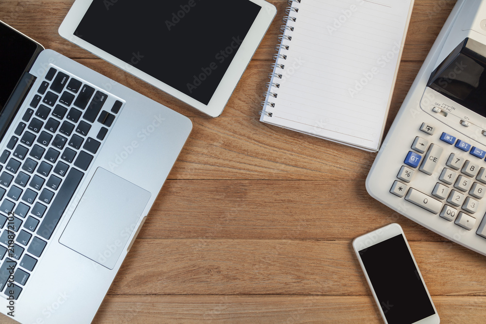 Open laptop with digital tablet and white smartphone, business and investment concept Open laptop with digital tablet and white smartphone, business and investment concept
