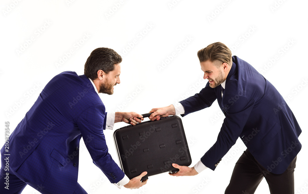 Businessmen or men in classic suits pulling black briefcase. Businessmen or men in classic suits pulling black briefcase.