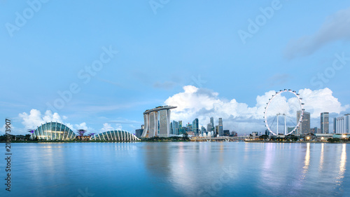 Photography Sun rising over the downtown skyline of Singapore as viewed from across the water from The Garden East