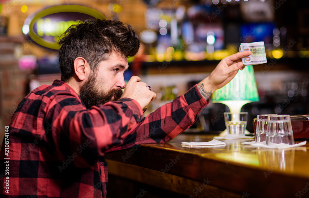 Alcohol addicted concept. Hipster holds glass with alcoholic drink