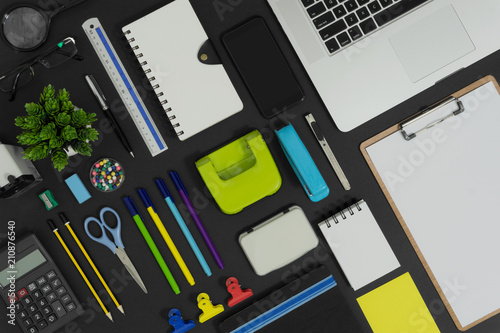 Multiple stationery items and devices for office and school. Top view flat lay of office supply.