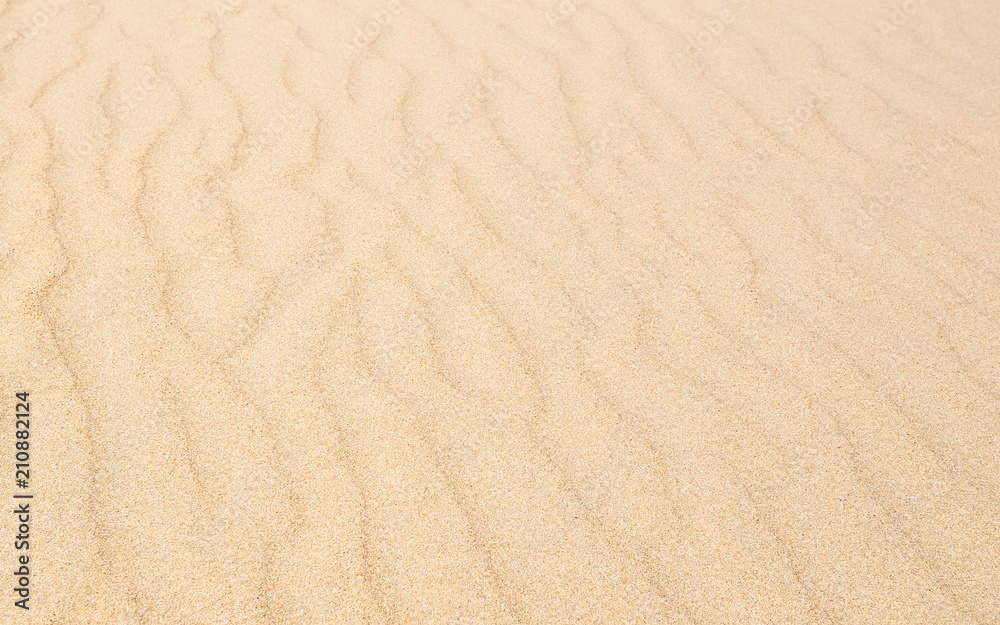 Sand waves texture with diagonal pattern. Sandy beach for background. Perspective view