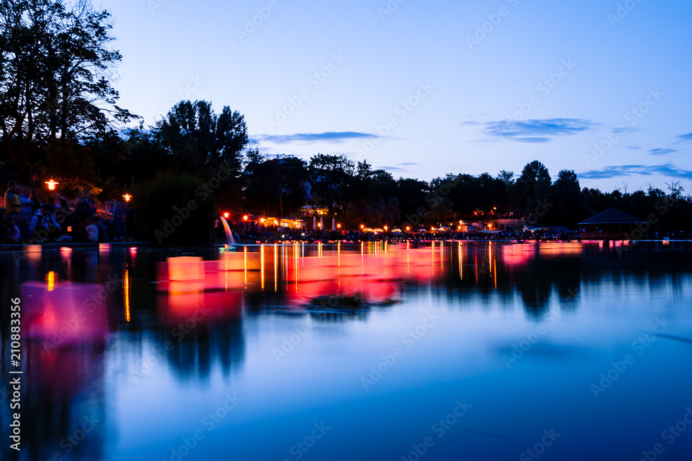Wish lanterns reflections with burning candles on a lake on summer night. Long exposures. Wish lanterns reflections with burning candles on a lake on summer night. Long exposures.