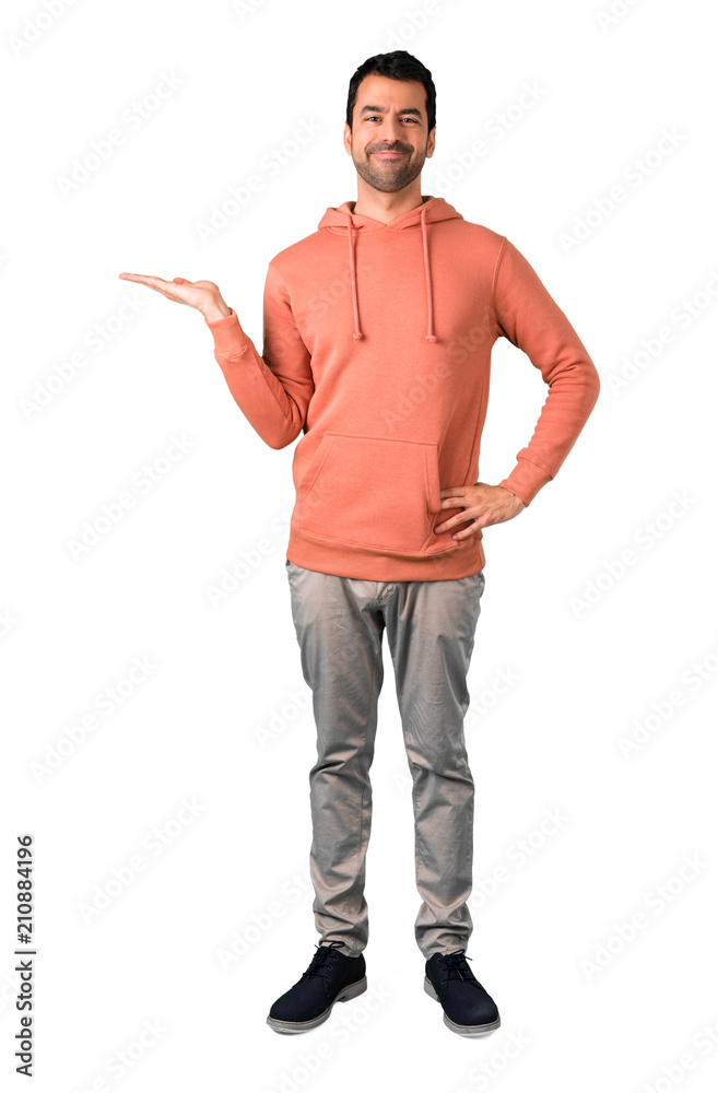 Full body of Man in a pink sweatshirt holding copy space imaginary on the palm to insert an ad on isolated white background Full body of Man in a pink sweatshirt holding copy space imaginary on the palm to insert an ad on isolated white background