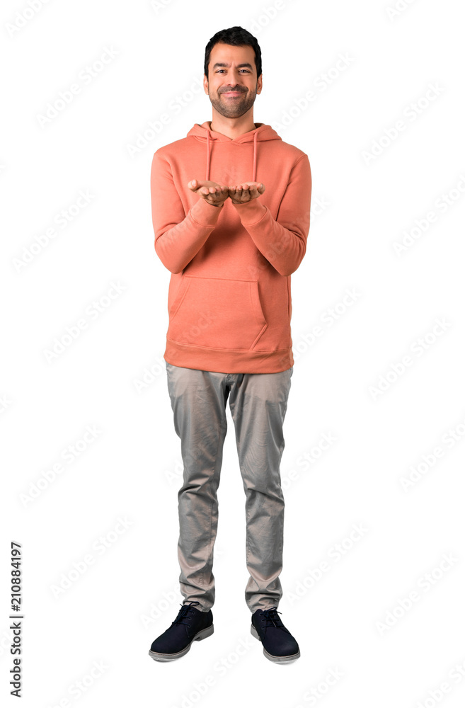 Full body of Man in a pink sweatshirt holding copy space imaginary on the palm to insert an ad on isolated white background Full body of Man in a pink sweatshirt holding copy space imaginary on the palm to insert an ad on isolated white background