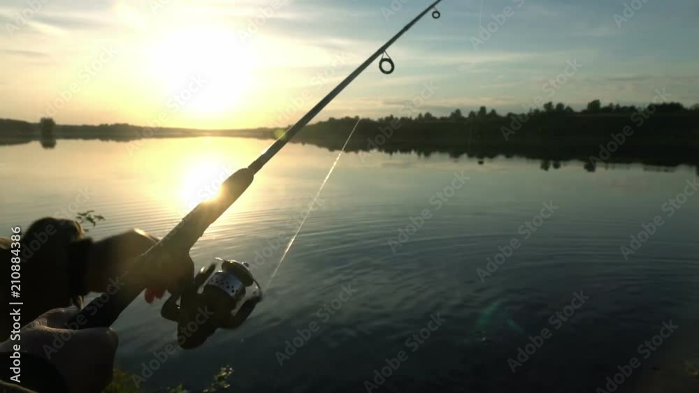 Silhouette of a fisherman at sunset. Fishing on the lake. hobby. Silhouette of a fisherman at sunset. Fishing on the lake. hobby.