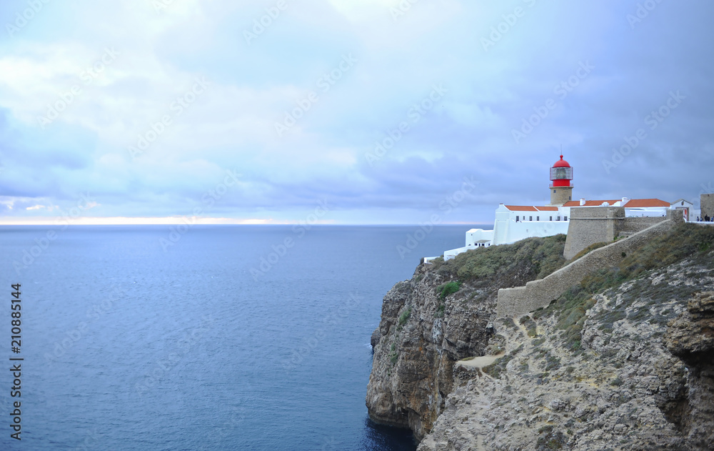 Amazing lighthouse on cliffs at Cape St. Vincent. Algarve, Portugal. The most extreme geographical point in the southwest of Continental Europe