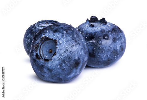 Three fresh blueberries with leaves isolated on white background