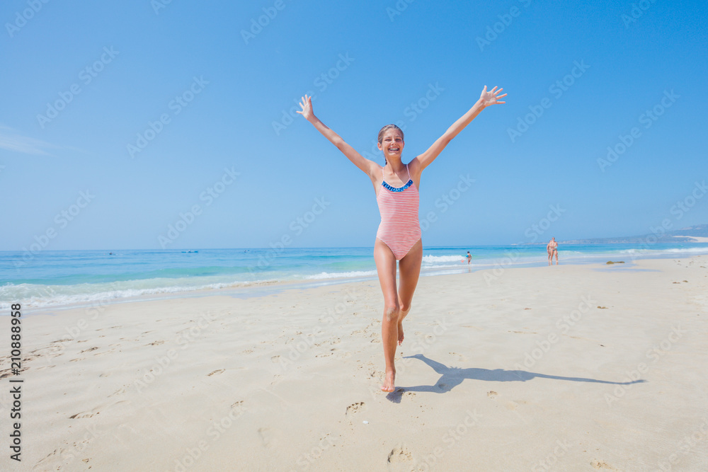 Girl in swimsuit runing and having fun on tropical beach Girl in swimsuit runing and having fun on tropical beach