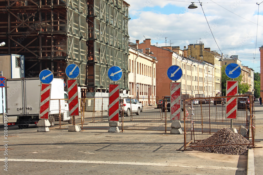 fencing and signs of detour of road works on the roadway