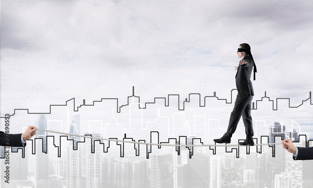 Business concept of risk support and assistance with man balancing on rope
