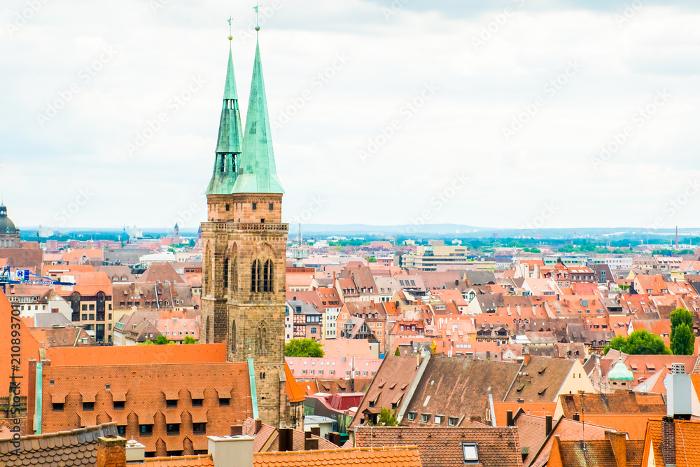 Cityscape of Nuremberg with red roofs and church in Germany