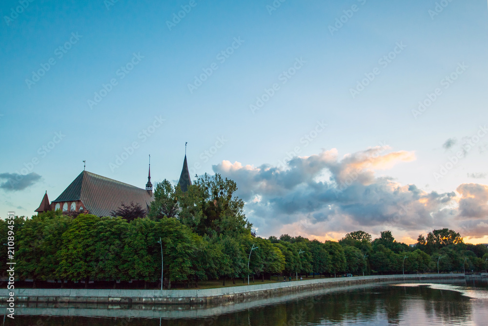 Fototapeta premium old beautiful Gothic cathedral church on the banks of the pregola river at dusk