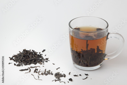 Glass of black tea on white background