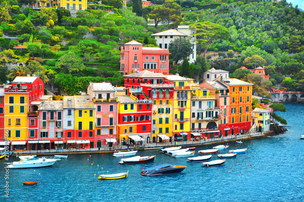 The beautiful Portofino with colorful houses and villas, luxury yachts and boats in little bay harbor. Liguria, Italy, Europe