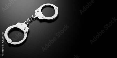 Metal handcuffs isolated on black background, 3d illustration photo